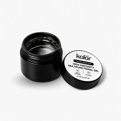 An open black jar of Kolor Enriched Soak Off High Viscosity Multifunctional Gel with its white lid placed beside it on a clean white background.